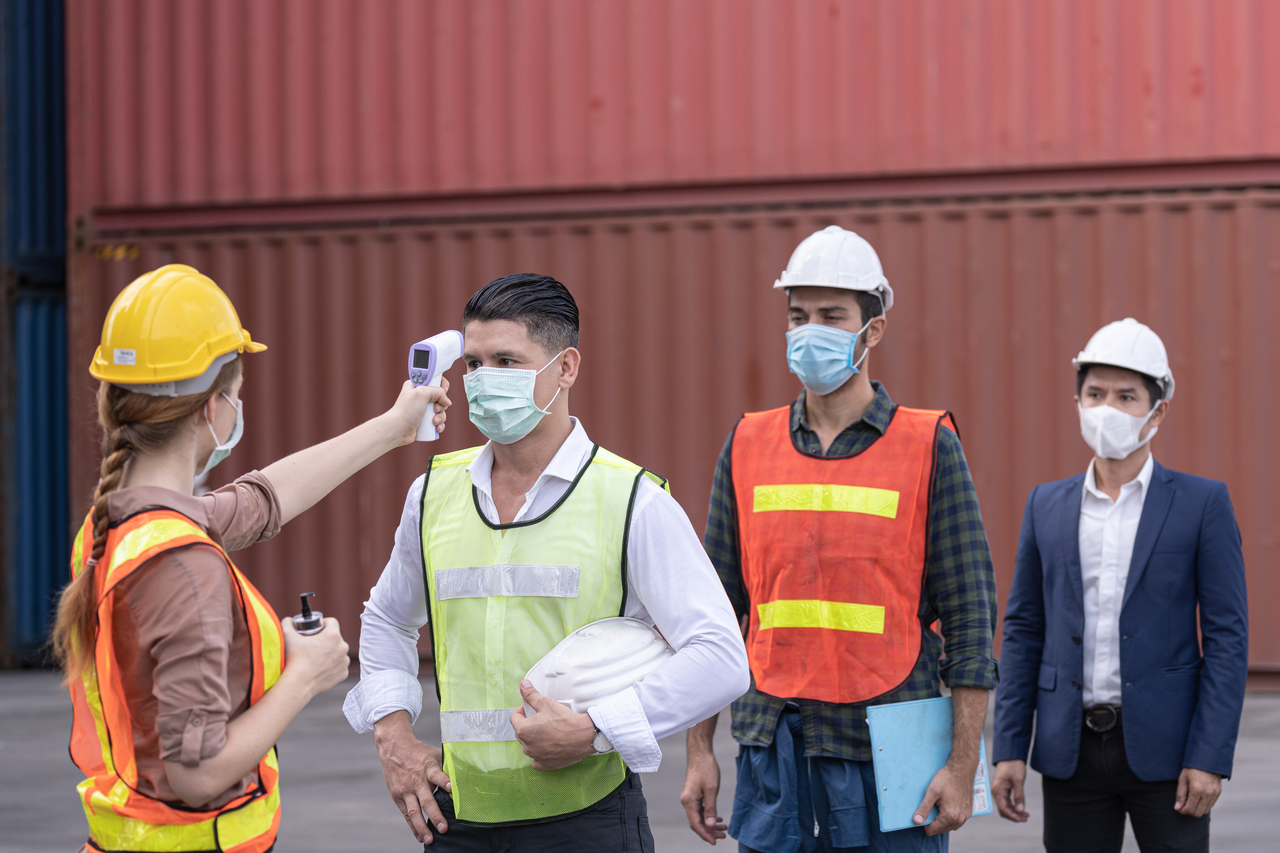 Workers lined up to get their temperature taken